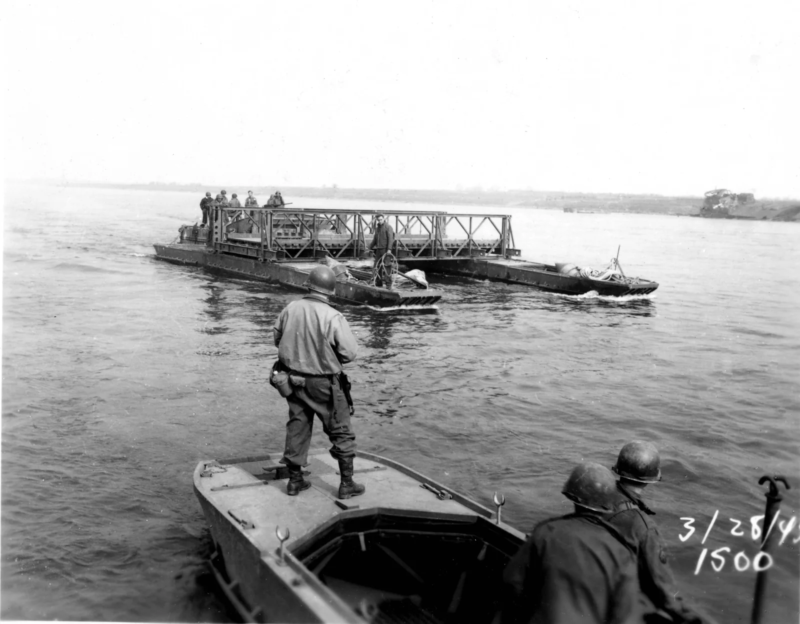 US engineers moving a Bailey bridge span on pontoons across the Rhine near Wesel, 28 March 1945.